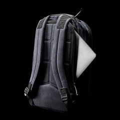 GORUCK black tactical backpack with padded straps and a laptop partially inserted in side pocket