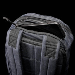 GORUCK Bullet Waxed Pack back view in black with phone partially inside top zipper pocket