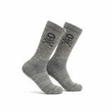 The Tribe Merino Challenge Socks - Crew are gray crew socks featuring a black skull and crossbones design on the side, shown against a white background.