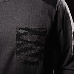 Close-up of charcoal long-sleeve shirt with black camo-patterned pocket detail on chest