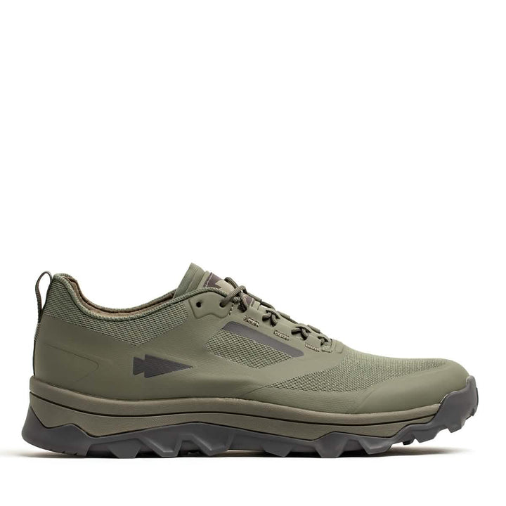 A GORUCK Mackall - Earth + Forged Iron trail shoe with a rugged triple compound outsole and streamlined design is displayed against a white background. Equipped with laces and a subtle arrow logo on the side, it seamlessly combines style and functionality, making it ideal for outdoor activities like rucking.