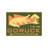 Illustration of an alligator, a tree, and "15 MI GORUCK EVERGLADES" on a green and orange badge, celebrating the Everglades Ruck event.