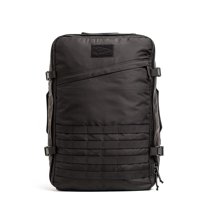The GR3 - Ripstop ROBIC® by GORUCK, made from sturdy Robic nylon, boasts side buckle straps and a front grid pattern. With a top handle and dependable zippers, this carry-on rucksack is engineered for exceptional durability and functionality.