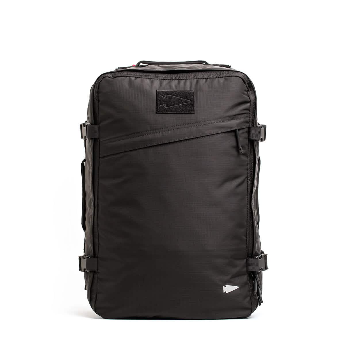 Introducing the GR3 - Ripstop ROBIC® by GORUCK: a sleek black carry-on rucksack with a rectangular design, constructed from robust Robic nylon. It includes multiple zippers, side buckle straps, and a small triangular logo prominently displayed on the top front—perfect for travel or outdoor adventures.
