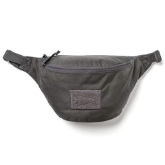 GORUCK black tactical fanny pack with zippered front pocket and arrowhead patch on a white background