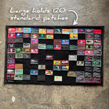GORUCK large patch board on concrete, displaying colorful rucking gear patches, holds 120 patches