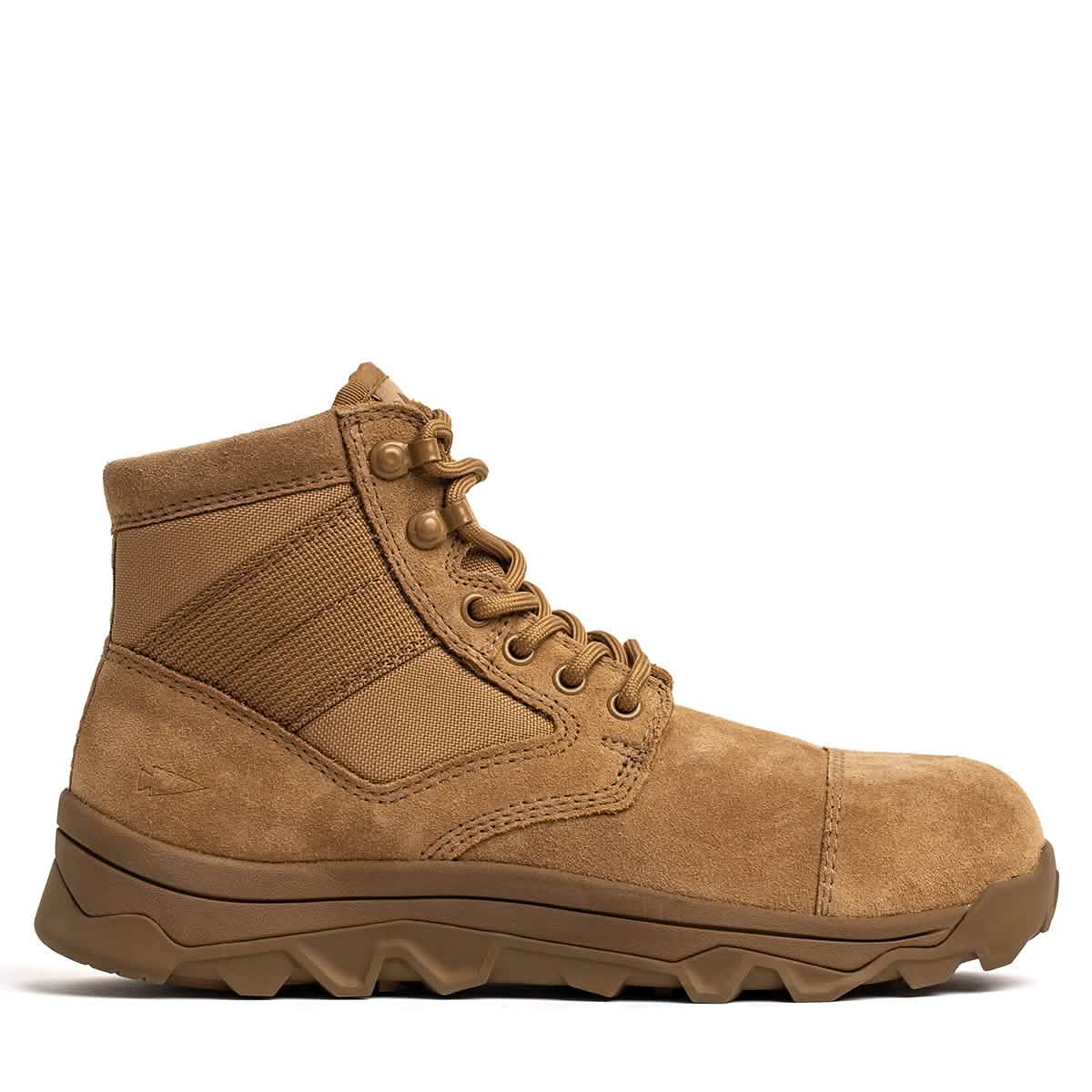 The MACV-2 Safety Boot - Mid Top from GORUCK is a single tan combat boot featuring a rugged sole and lace-up closure. It is crafted from suede and fabric, meeting Special Forces standards. The design is both sturdy and practical, making it ideal for outdoor or tactical use. The boot is displayed from the side against a white background.
