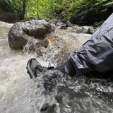 GORUCK rucking shoes and pants in action crossing a rocky stream in a forest setting