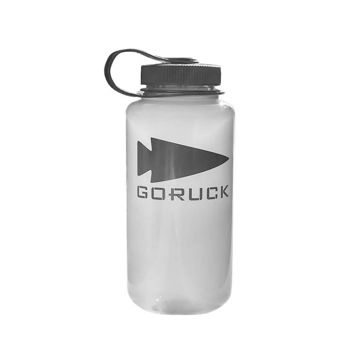 The Nalgene Water Bottle (32oz) - GORUCK Spearhead features a clear body, black lid with loop handle, and spearhead logo. Durable and versatile, it's ideal for everyday use or pairing with a hydration bladder.