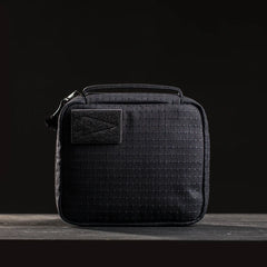 GORUCK compact black tactical pouch with grid texture and arrow patch on dark background