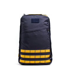 The GR1 rucksack, featuring a dark gray color with yellow horizontal straps and a front zipper pocket, is displayed against a white background.