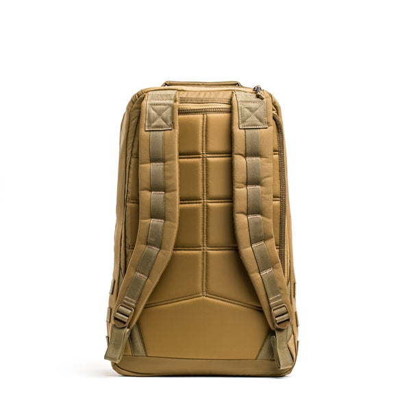 The GR1 rucksack is shown from the back with padded straps and a quilted back panel, set against a white background.