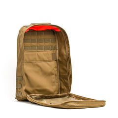 GR1 backpack in tan shown open, revealing interior pockets, a mesh pouch, and an orange lining near the top.