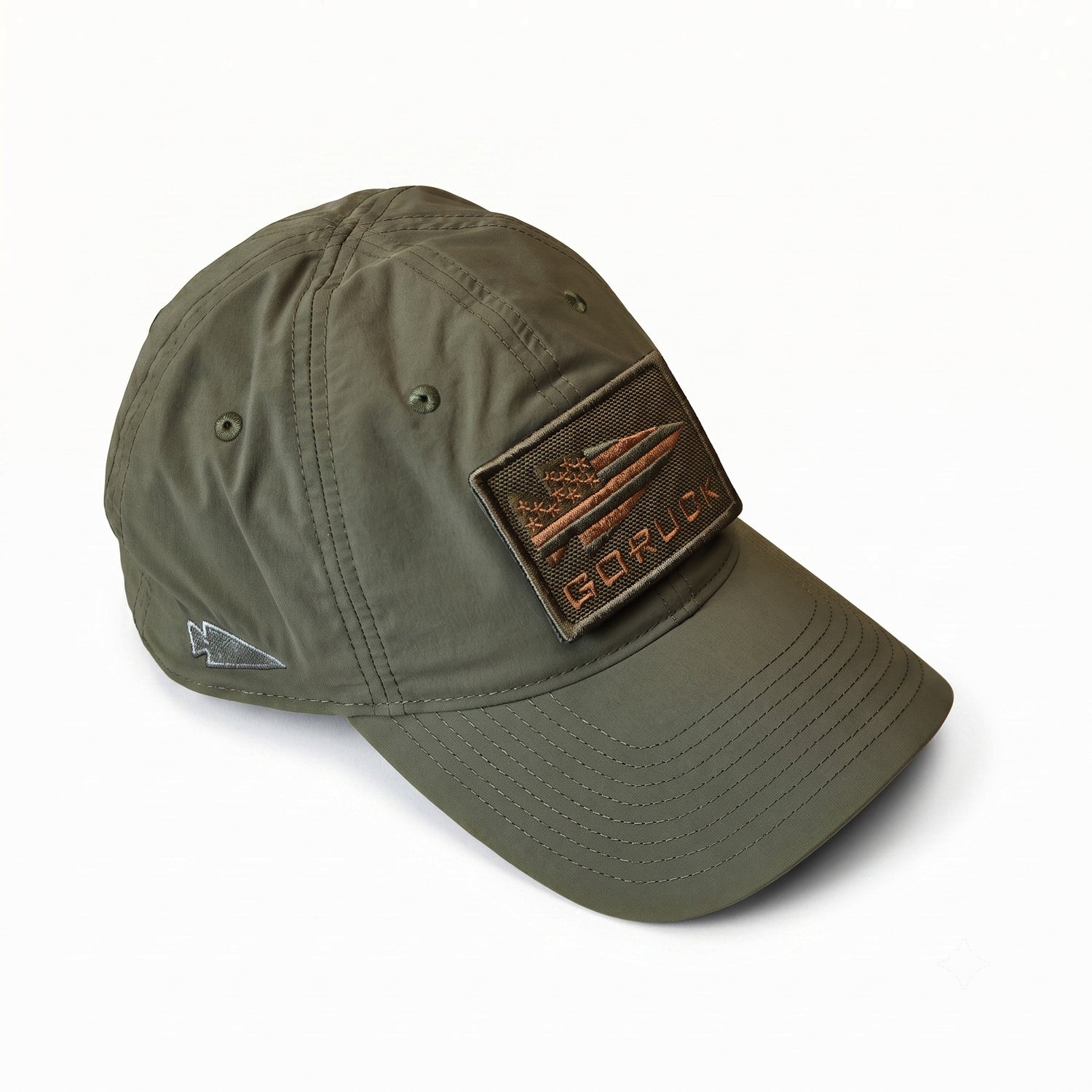 The Performance TAC Hat - TOUGHDRY is an olive green baseball cap made from durable ToughDry fabric, showcasing a rectangular “GORUCK” patch on the front and a small embroidered logo on the side. This military-style hat delivers both durability and comfort for any adventure.