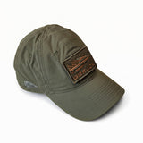 The Performance TAC Hat - TOUGHDRY is an olive green baseball cap made from durable ToughDry fabric, showcasing a rectangular “GORUCK” patch on the front and a small embroidered logo on the side. This military-style hat delivers both durability and comfort for any adventure.
