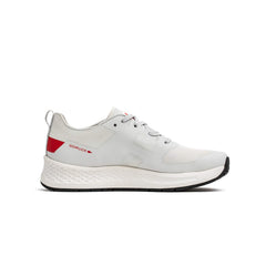 The Men's Rough Runner - Light Grey + Red is a lightweight running shoe with red accents, a textured white sole, and a Gradient Density EVA midsole for extra comfort—ideal for everyday wear.