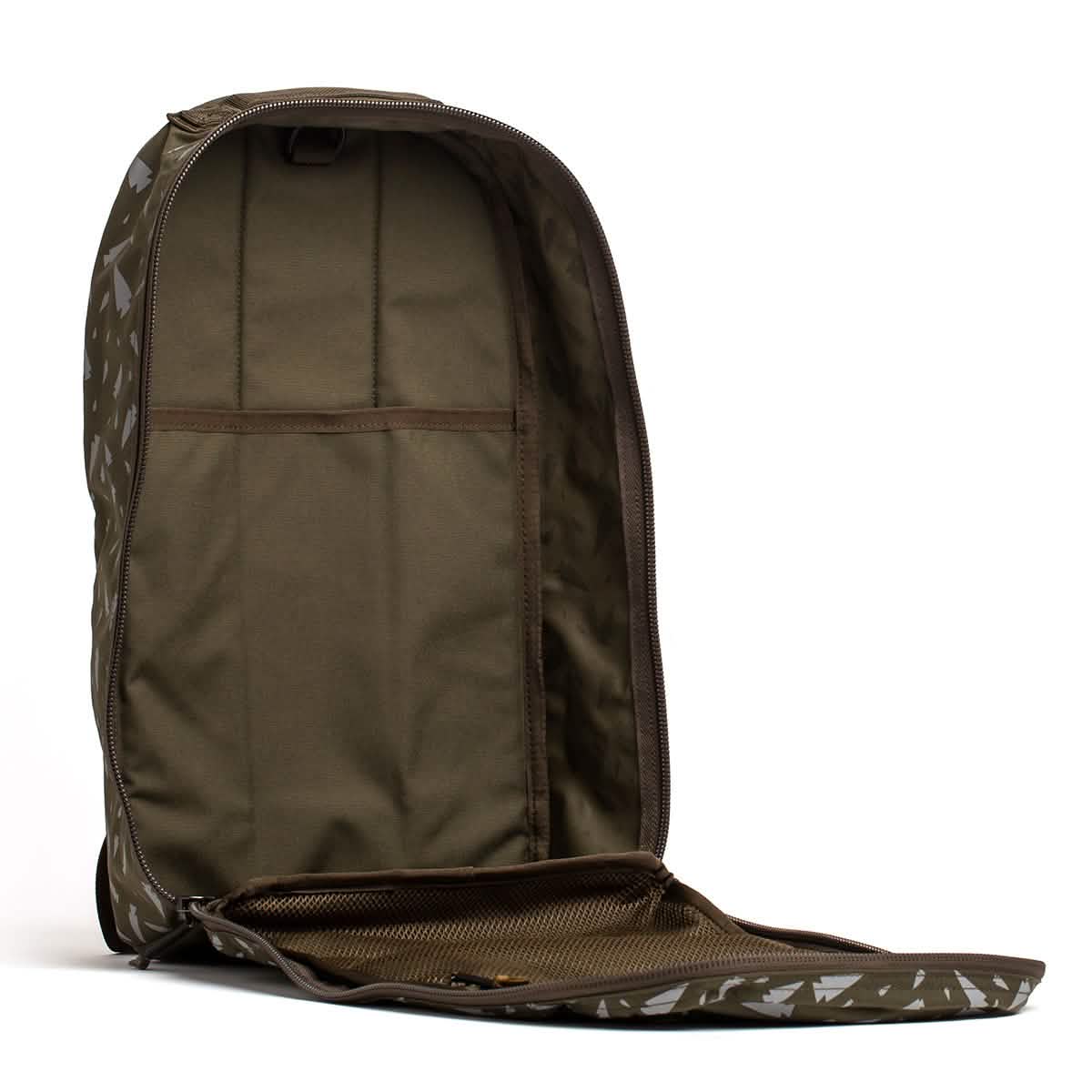 The open Bullet Ruck - Classic - Reflective Spearhead by GORUCK is displayed in brown, crafted from durable Cordura fabric. This 15L daypack features a single compartment with a main pocket and a mesh section inside the front flap. With the zipper fully open, the bag's spacious interior is shown, ideal for holding a Ruck Plate or daily essentials.