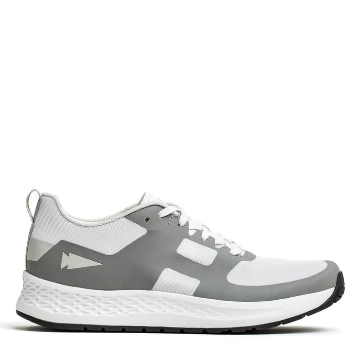 The GORUCK Men's Rough Runner - White + Speed Grey athletic sneaker features a textured sole in the side view, with a white upper complemented by speed grey overlays. It includes white laces and a pull tab at the heel. The modern design is enhanced for high mileage running by the Gradient Density™ EVA Midsole.