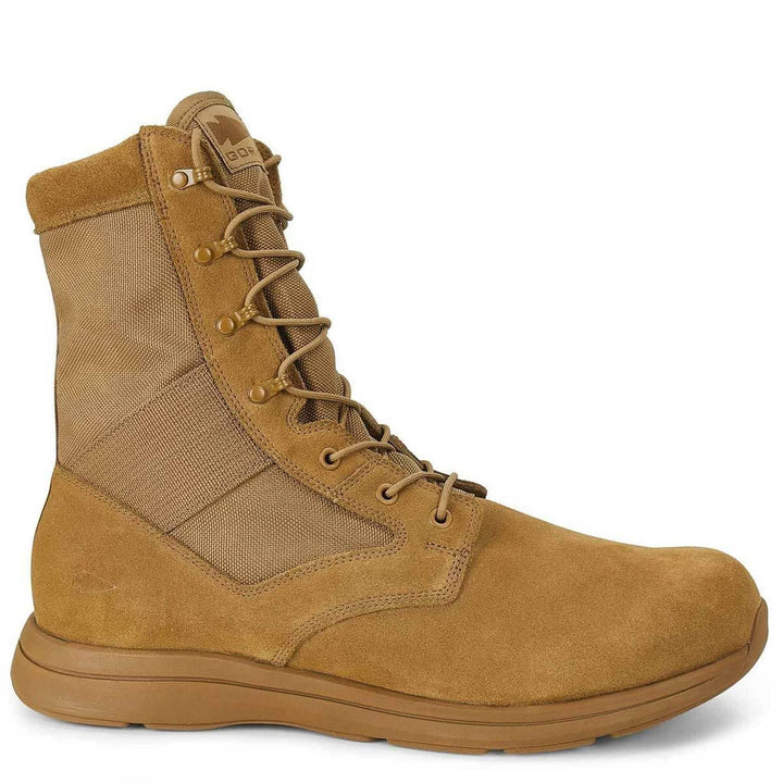 The MACV-1 - High Top in Coyote Suede from GORUCK is a tan military-style boot featuring a high ankle and lace-up design. It includes a rugged all-terrain outsole, and its construction boasts a suede leather upper with reinforced heel and toe, making it durable for outdoor use.