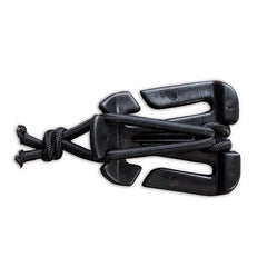 The GORUCK Bladder Hose Retainer is made from black plastic, featuring multiple slots and extensions, with paracord and an elastic shock cord intricately threaded through it to form a neat knot, all set against a white background.