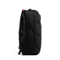 Side view of the GR1 USA x Carryology - GRXC2 Samurai black backpack, made from Japanese cotton fabric with a textured grid pattern, against a white background.