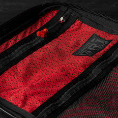 The GR1 USA x Carryology - GRXC2 Samurai features a red Japanese cotton fabric pouch with black zippers, geometric patterns, and a small logo patch on the inner lining.