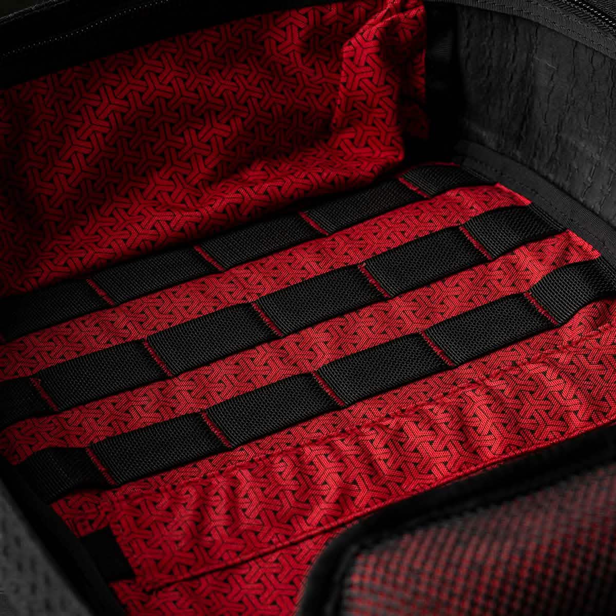Close-up of the GR1 USA x Carryology - GRXC2 Samurai backpack’s red and black patterned Japanese cotton interior with black horizontal straps—part of the exclusive collaboration.