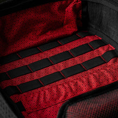 Close-up of the GR1 USA x Carryology - GRXC2 Samurai backpack’s red and black patterned Japanese cotton interior with black horizontal straps—part of the exclusive collaboration.