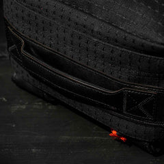 Close-up of a black Japanese cotton fabric bag featuring a stitched handle and small orange thread detail, part of the GR1 USA x Carryology - GRXC2 Samurai collection.