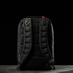 The GR1 USA x Carryology - GRXC2 Samurai, a black backpack with padded shoulder straps made from premium Japanese cotton fabric, is displayed from the back against a dark background.