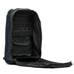 The GR1 USA - Heritage by GORUCK is a black rucksack made from waxed duck canvas with a fully opening main compartment secured by a zipper. Inside, it features multiple organizing sleeves and mesh pockets for efficient storage and easy access, all enhanced by a robust Martexin Wax finish.