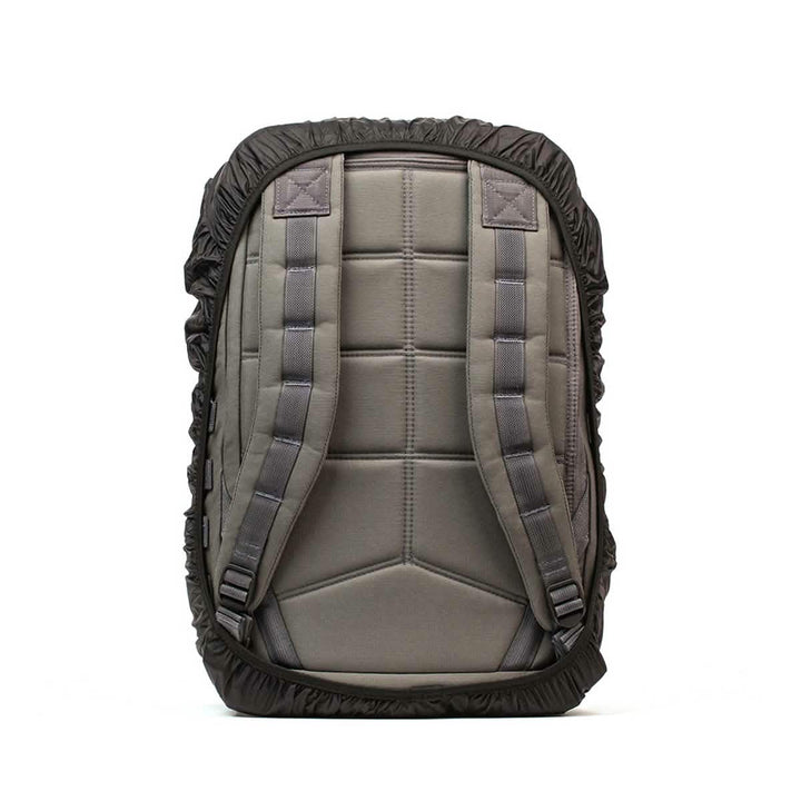 The GORUCK Ruck Rain Cover, a gray backpack equipped with padded shoulder straps, features a sleek black rain cover and is displayed from the back. Its durable fabric and minimalist design make it a versatile accessory for any weather conditions.