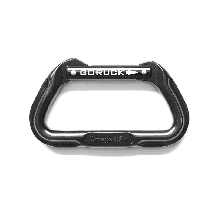 A sleek black aluminum carabiner, certified for climbing and equipped with ISO Cold Forging, displays the GORUCK Logo on the gate. "Omega USA" is elegantly engraved on its lower part against a plain white background. This product is part of SMC Gear's collection.