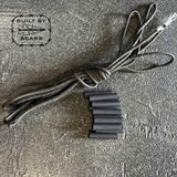 GORUCK paracord and heat shrink tubing kit on textured gray surface, Built by Scars logo