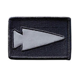 GORUCK reflective spearhead patch on black rectangular fabric background