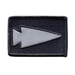 GORUCK reflective spearhead patch on black rectangular fabric background