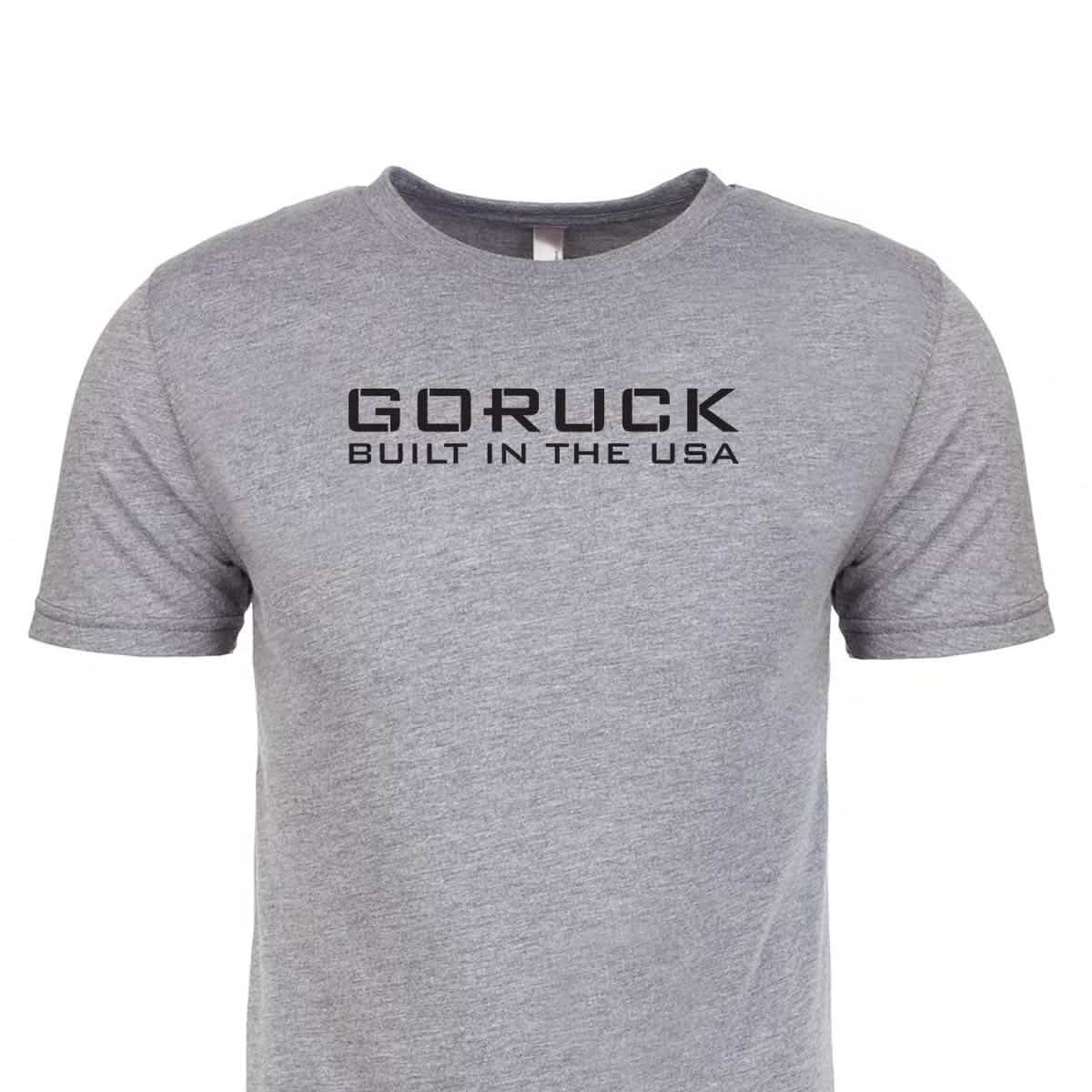 The Reverse Flag Tee - Tri-Blend by vendor-unknown is a gray T-shirt with black text on the front that reads 
