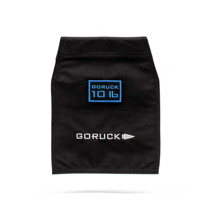 A sleek VELCRO® closure design characterizes the Ruck Sandbag - 10LB by GORUCK. It features a black fabric patch with "GORUCK 10 LB" in blue at the top, and underneath, "GORUCK" is displayed in white alongside a sideways arrowhead symbol.