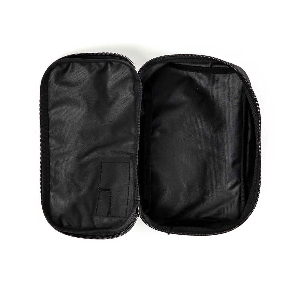 The GORUCK Shadow Pockets pouch, constructed from durable Cordura, comes in black with a zipper closure and two main compartments set against a white background. On the left side, it includes a small fabric pocket designed for efficient ruck organization, while the larger compartment on the right remains empty.