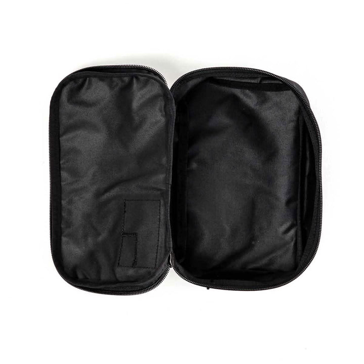 The GORUCK Shadow Pockets pouch, constructed from durable Cordura, comes in black with a zipper closure and two main compartments set against a white background. On the left side, it includes a small fabric pocket designed for efficient ruck organization, while the larger compartment on the right remains empty.