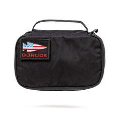 Black GORUCK Shadow Pocket pouch with American flag arrow patch and top handle