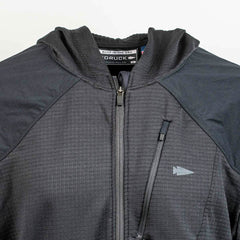 A close-up of the Men’s Full Zip - Polartec Grid Fleece by GORUCK highlights its Polartec Power Grid material, featuring a hood and multiple zippers. The chest is adorned with a small arrow logo, while the tag inside the collar is visible. The textured grid pattern suggests its sturdy ToughDry Fabric construction.