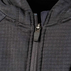 Close-up of a dark gray Men’s Full Zip - Polartec Grid Fleece jacket by GORUCK with a partially zipped zipper. The metal zipper pull features the YKK engraving, highlighting its quality. The textured surface suggests durable craftsmanship and style.