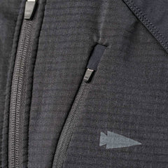 Close-up of the GORUCK Men's Full Zip - Polartec Grid Fleece jacket in a gray-textured fabric, showcasing a partially closed zipper. Above it, there’s a small zippered pocket with a pull tab. On the right side of the ToughDry Fabric, a subtle arrow-shaped design adds both durability and style to this fleece-lined jacket.