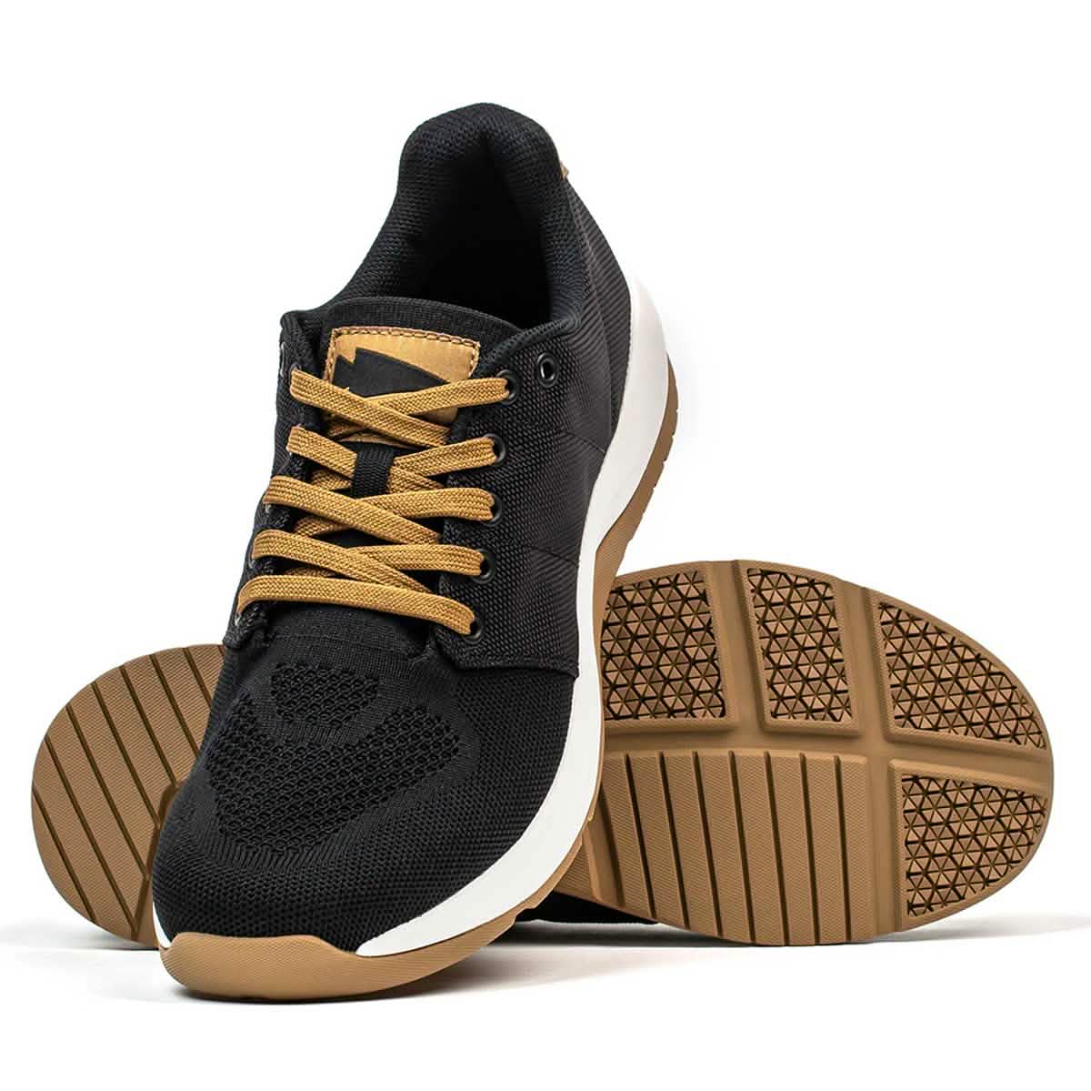Introducing the Men's Ballistic Trainers by GORUCK in Black, White, and Coyote. This pair of athletic shoes is crafted with durable CORDURA® Ballistic Nylon, showcasing brown soles and laces. One shoe is positioned upright while the other is on its side, revealing the intricate pattern of the textured sole. These functional fitness footwear pieces are enhanced with white midsole accents for a stylish touch.