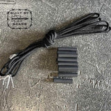 Black GORUCK paracord and heat shrink tubing kit on textured gray surface, built by Scars logo