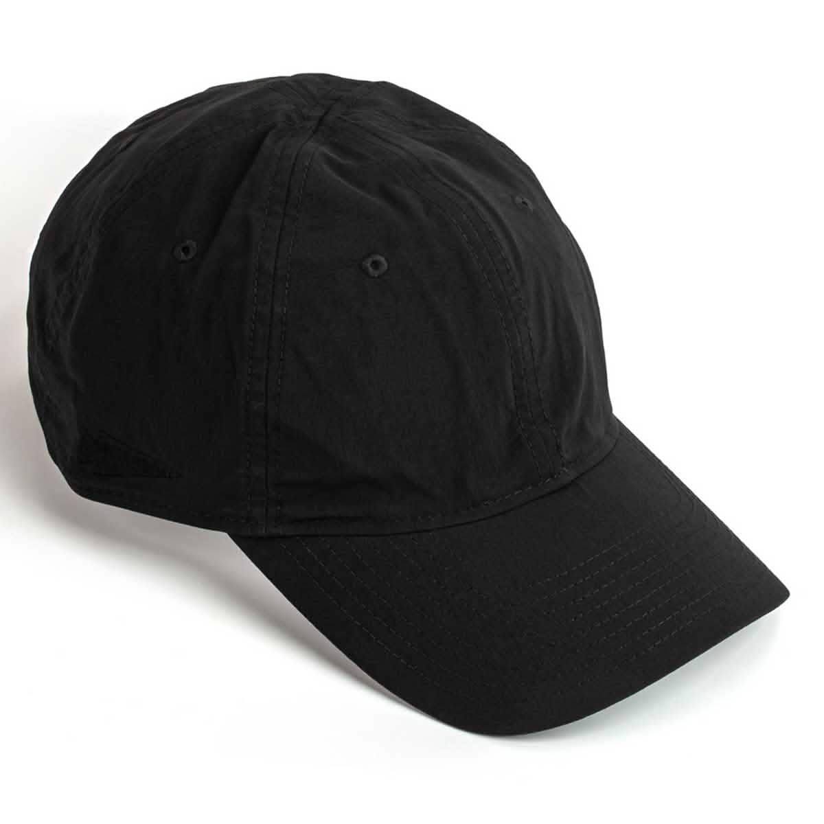 The Performance TAC Hat - Slick - TOUGHDRY by GORUCK is showcased in black with a curved brim and angled to the right. The hat boasts a classic design crafted from ToughDry® fabric, featuring visible stitching and ventilation holes on top.