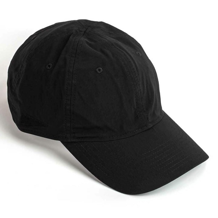 The Performance TAC Hat - Slick - TOUGHDRY by GORUCK is showcased in black with a curved brim and angled to the right. The hat boasts a classic design crafted from ToughDry® fabric, featuring visible stitching and ventilation holes on top.