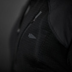 Close-up of black GORUCK rucking jacket fabric with zipper and subtle logo detail