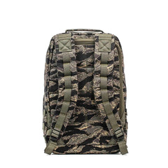 The GR1 - USA - Tiger Stripe rucksack features a camouflage pattern, padded shoulder straps, and a top handle, all inspired by Special Forces backpack design.